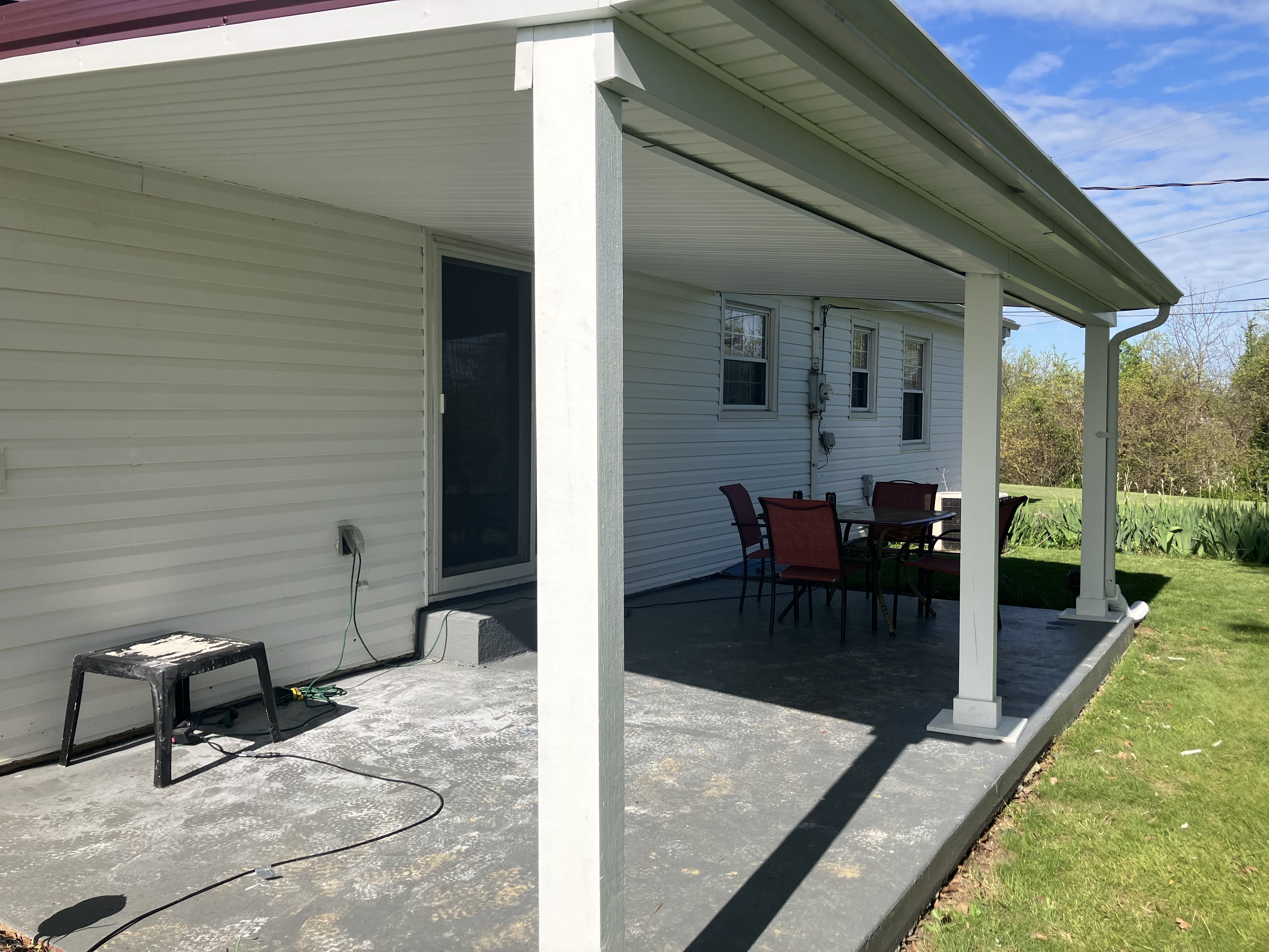Completed covered patio with wrapped columns and finished roof